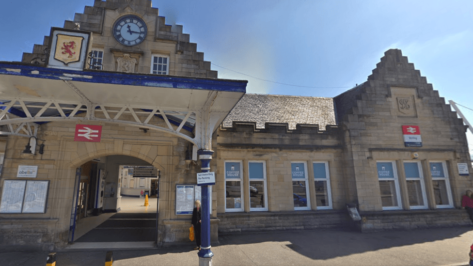 The outside of Stirling railway station with a woman standing outside