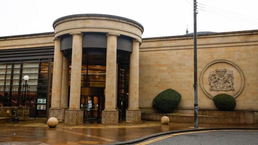 High Court in Glasgow. It is a sandstone building with columns at the front forming a circular entrance.